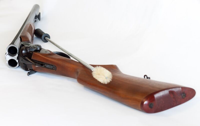 image of refinish wood gun stock with steel wool
