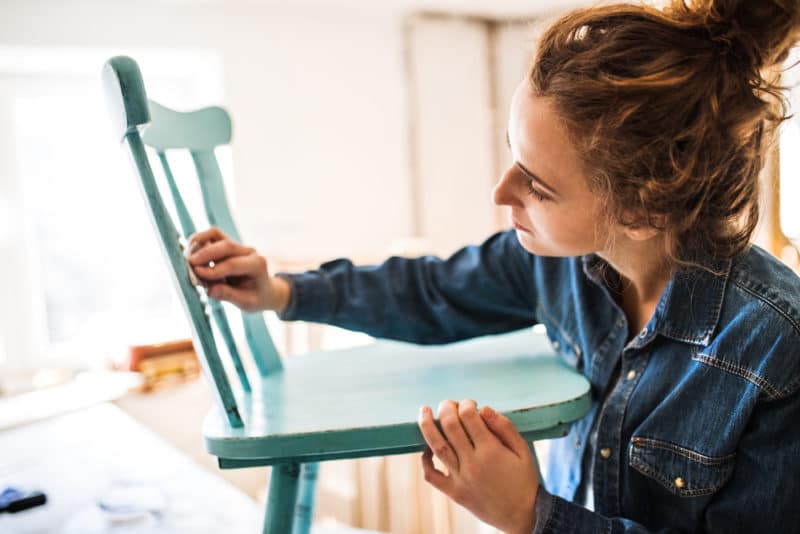 milk paint vs acrylic paint - woman painting furniture