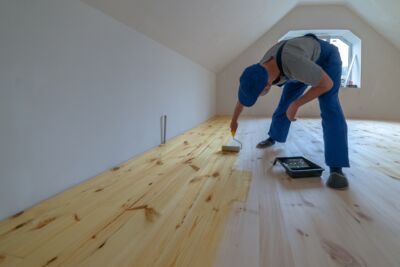 man applying Hemp Oil for Wood Finishing to his floor