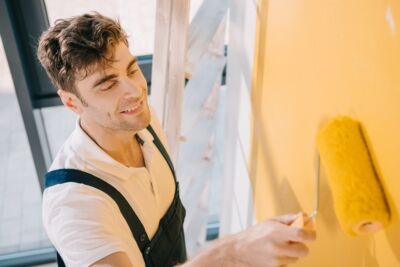 man enjoy painting wall with real milk paint